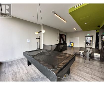 A modern bedroom with a large bed and a green accent wall.