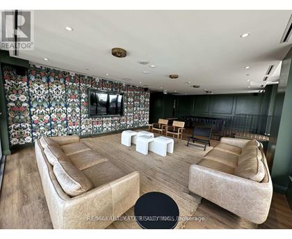 A living room with a floral wallpaper and a flat screen TV.