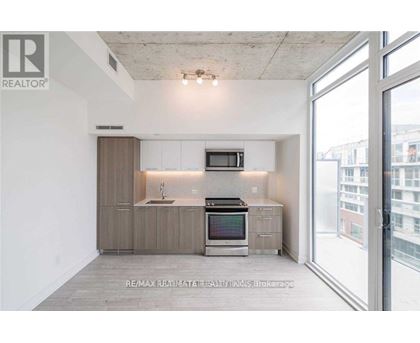 A modern kitchen with a large window overlooking the city.