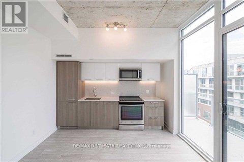 A modern kitchen with a large window overlooking the city.