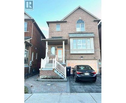 A two-story brick house with a car parked in front.