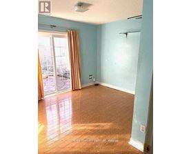 A room with light blue walls and wooden flooring.