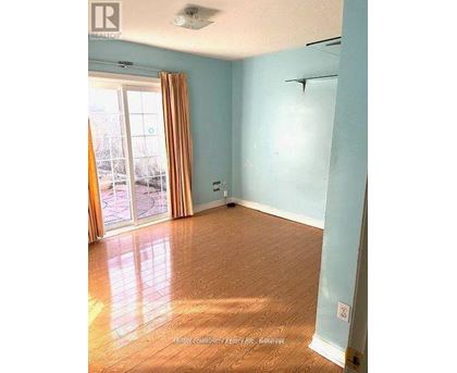 A room with light blue walls and wooden flooring.