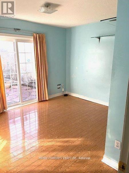 A room with light blue walls and wooden flooring.
