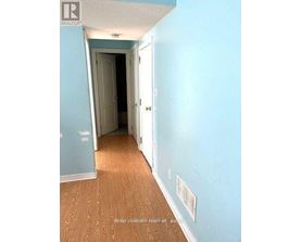 A hallway with a door on the left and a door on the right.