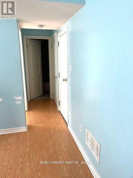 A hallway with a door on the left and a door on the right.