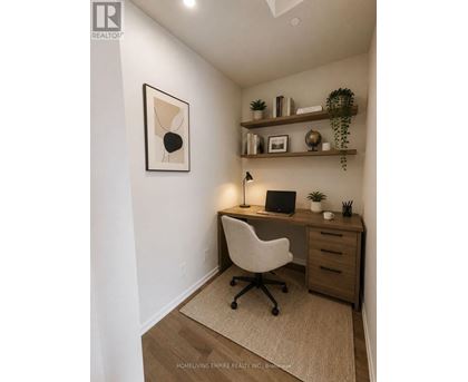 A home office with a desk, chair, and shelves with decorative items.