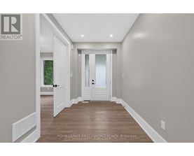 A hallway with a door and a window.
