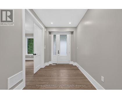 A hallway with a door and a window.
