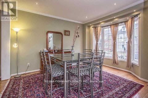 A dining room with a table and chairs.