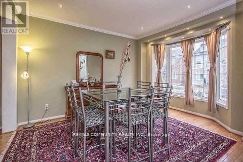 A dining room with a table and chairs.