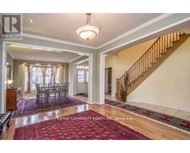 A spacious room with a dining table and chairs is shown.