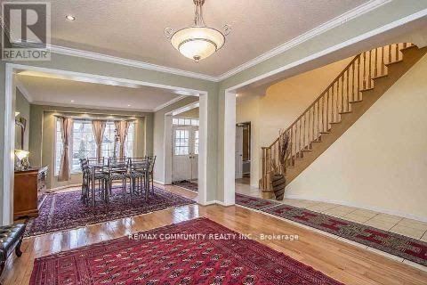 A spacious room with a dining table and chairs is shown.