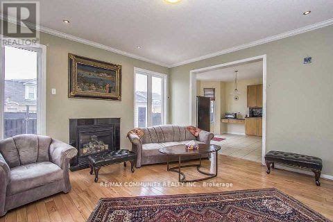 A living room with a fireplace and a painting on the wall.