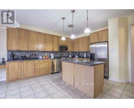 A kitchen with wooden cabinets and a tile floor.