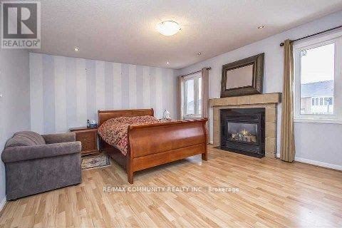 A bedroom with a fireplace and a bed.