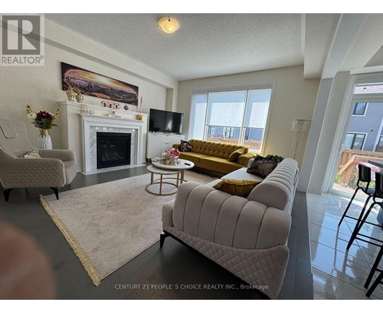 A living room with a fireplace and a painting on the wall.