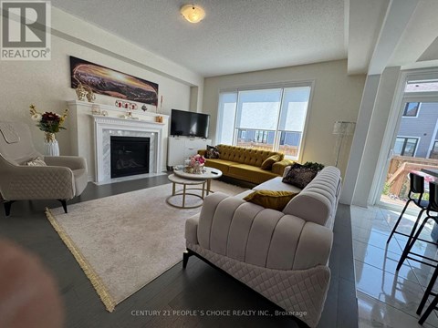 A living room with a fireplace and a painting on the wall.