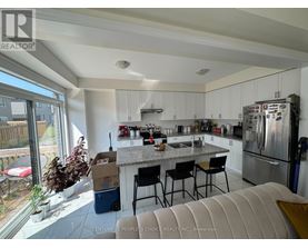 A kitchen with white cabinets and a granite countertop.