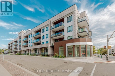 A modern apartment building with balconies and a clear sky in the background.