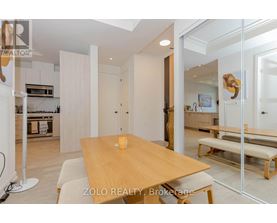 A dining area with a wooden table and bench seating.