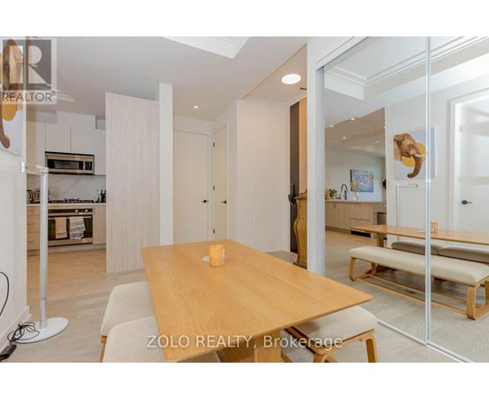 A dining area with a wooden table and bench seating.