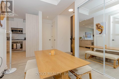 A dining area with a wooden table and bench seating.