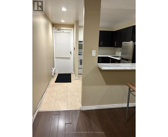 A hallway with a door and a mat on the floor.