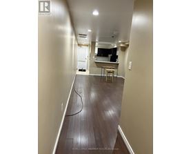 A long hallway with a table and chairs in the distance.