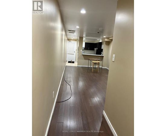 A long hallway with a table and chairs in the distance.