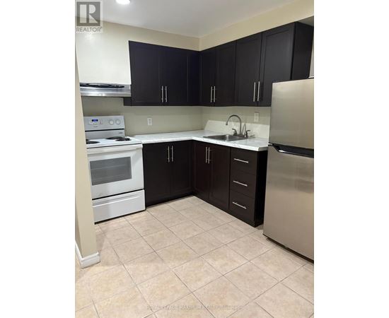 A kitchen with black cabinets and stainless steel appliances.