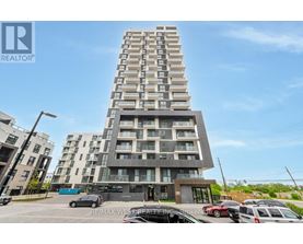 A tall residential building with a parking lot in front.