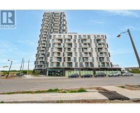 A tall residential building with a parking lot in front.