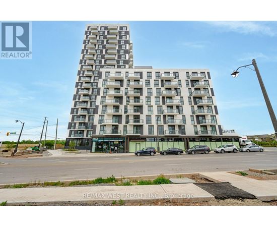 A tall residential building with a parking lot in front.