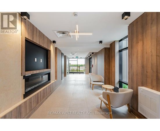 A modern living room with a flat screen TV and a wood panelled wall.