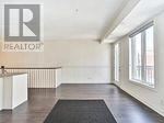 A realtor sign is on the wall in an empty room.