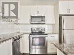 A kitchen with a stove top oven and a microwave above it.