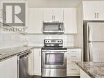A kitchen with a stove top oven and a microwave above it.