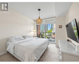 A bedroom with a large bed and a television.