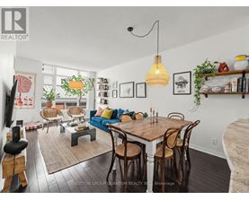 A dining room with a wooden table and chairs.