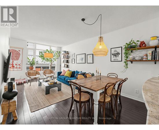 A dining room with a wooden table and chairs.