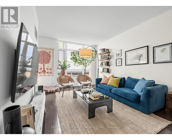 A living room with a blue couch and a television.