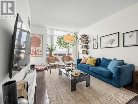 A living room with a blue couch and a television.