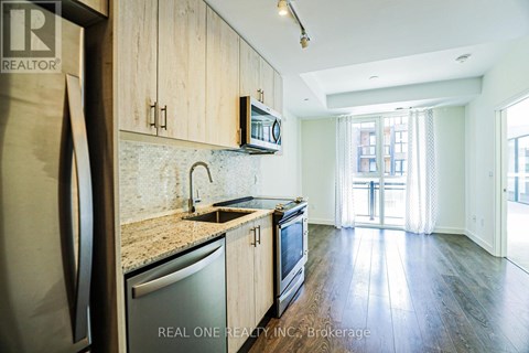 A kitchen with wooden cabinets and a granite countertop.