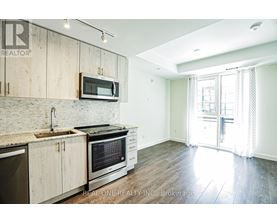 A kitchen with wooden cabinets and a stainless steel oven.