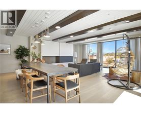 A modern dining room with a large table and chairs.