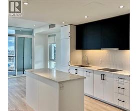 A modern kitchen with white cabinets and a large island.