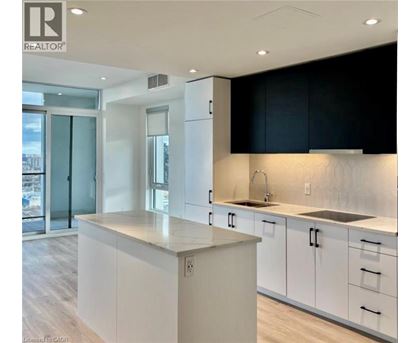 A modern kitchen with white cabinets and a large island.