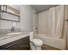 A bathroom with a toilet, sink, and bathtub.
