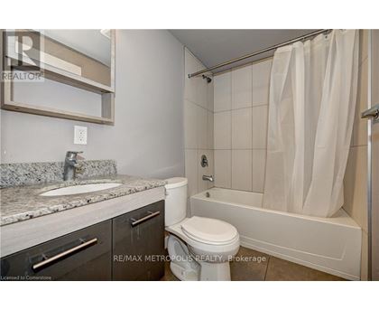 A bathroom with a toilet, sink, and bathtub.